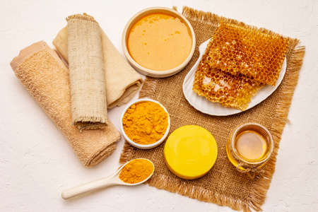 Spa concept. Self care with honey and turmeric. Natural organic cosmetics, homemade product, alternative lifestyle. White putty backgroundの写真素材
