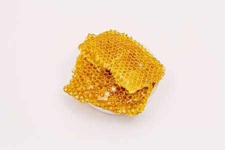 Honey and honeycombs isolated on white background. Sweet healthy bee productsの写真素材