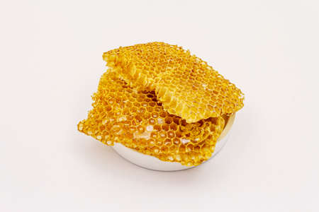Honey and honeycombs isolated on white background. Sweet healthy bee productsの写真素材
