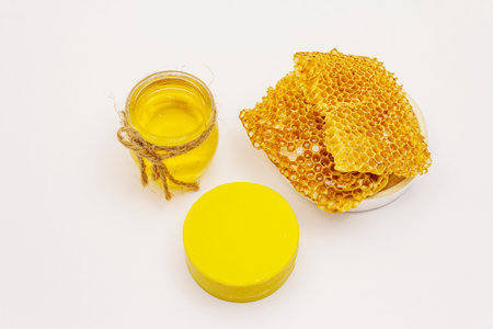 Honey, beeswax and honeycombs isolated on white background. Sweet healthy bee productsの写真素材