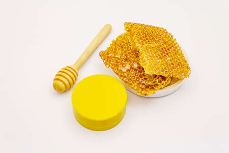 Honey, beeswax and honeycombs isolated on white background. Sweet healthy bee products, cosmetics soap from natural ingredientsの写真素材