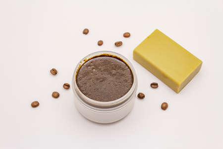 Coffee body scrub and soap isolated on white background. Spa concept, homemade cosmetics from natural ingredientの写真素材