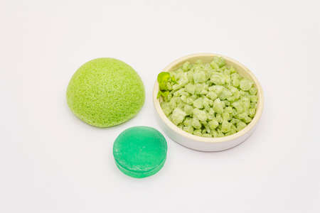 Sea salt, green tea soap and sponge isolated on white background. Spa concept, homemade cosmetics from natural ingredientの写真素材