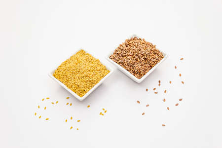 Brown and golden flax seeds isolated on white background. Trendy superfood, ingredient for making healthy foodの写真素材