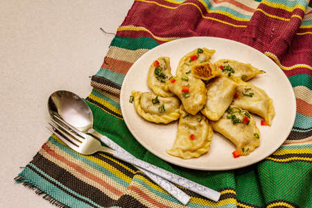 Dumplings stuffed stewed cabbage and sour cream. Traditional Ukrainian dish v-arenyky. Healthy vegan...