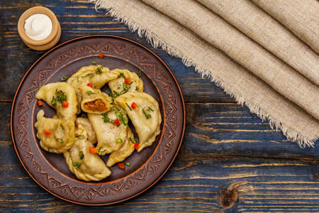 Dumplings stuffed stewed cabbage and sour cream. Traditional Ukrainian dish varenyky. Healthy vegan...