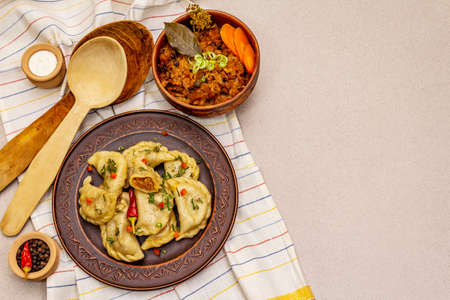 Dumplings stuffed stewed cabbage and sour cream. Traditional Ukrainian dish v-arenyky. Healthy vegan (vegetarian) food. Stone concrete backgroundの写真素材