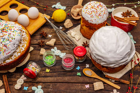 Easter cake decoration. Icing-sugar, topping, edible beads. Natural healthy ingredients, vintage wooden tableの写真素材