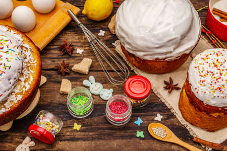 Easter cake decoration. Icing-sugar, topping, edible beads. Natural healthy ingredients, vintage wooden tableの写真素材