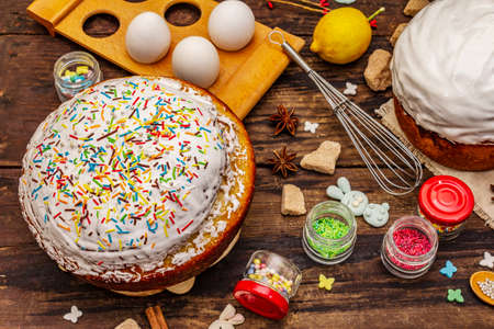 Easter cake decoration. Icing-sugar, topping, edible beads. Natural healthy ingredients, vintage wooden tableの写真素材
