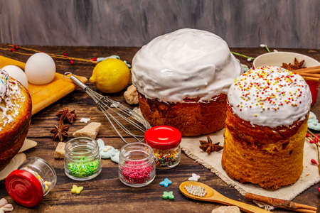 Easter cake decoration. Icing-sugar, topping, edible beads. Natural healthy ingredients, vintage wooden tableの写真素材