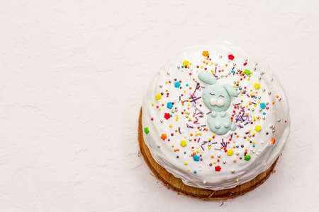 Easter cake on white putty background. Traditional Orthodox festive bread, wooden standの写真素材
