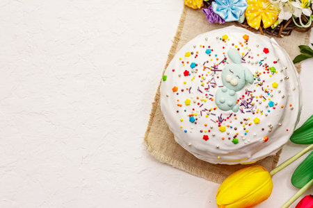 Easter cake on white putty background. Traditional Orthodox festive bread, wooden stand