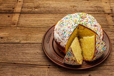 Easter cake on old wooden table. Traditional Orthodox festive bread, cut piecesの写真素材