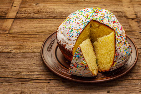 Easter cake on old wooden table. Traditional Orthodox festive bread, cut piecesの写真素材