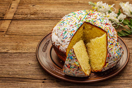 Easter cake on old wooden table. Traditional Orthodox festive bread, cut piecesの写真素材