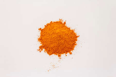 Hungarian hot paprika powder isolated on white background. Heap of traditional seasoningの写真素材