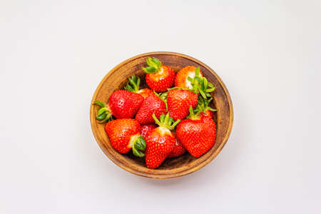 Sweet fresh strawberry isolated on white background. Ripe berries fruit in ceramic bowl, tasty ingredient for many dishesの写真素材