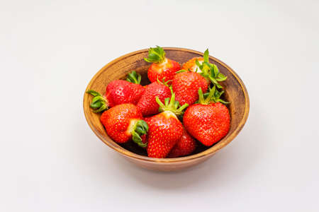 Sweet fresh strawberry isolated on white background. Ripe berries fruit in ceramic bowl, tasty ingredient for many dishesの写真素材