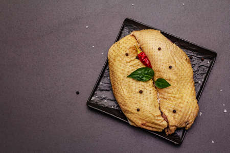 Raw duck breast and spices. Delicious ingredient for cooking healthy meal. Traditional French food. Black stone concrete background, top viewの写真素材