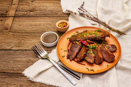 Roasted duck breasts, spices and Demi-glace sauce. Traditional French food, vintage wooden boards backgroundの写真素材