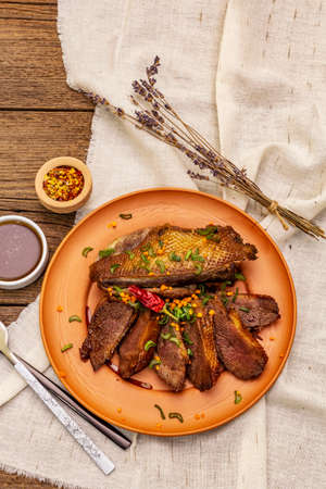 Roasted duck breasts, spices and Demi-glace sauce. Traditional French food, vintage wooden boards , top viewの写真素材