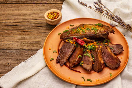 Roasted duck breasts, spices and Demi-glace sauce. Traditional French food, vintage wooden boards backgroundの写真素材