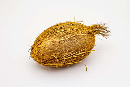 Fresh ripe coconut isolated on white background. Whole fruit, ingredient for healthy and beauty lifeの写真素材