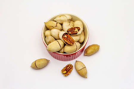 Ripe pecan isolated on white background. Traditional ingredient for pecan pie in USAの写真素材