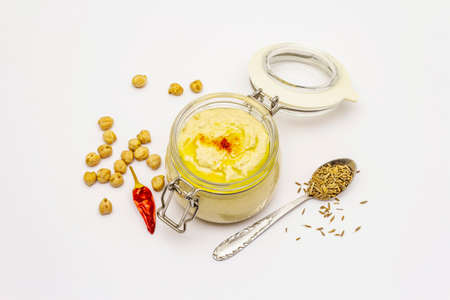 Hummus isolated on white background. Dry chickpea, cumin and chili pepper. Traditional food in Middle Eastern and Mediterranean cuisineの写真素材