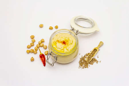 Hummus isolated on white background. Dry chickpea, cumin and chili pepper. Traditional food in Middle Eastern and Mediterranean cuisineの写真素材