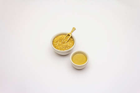 Tahini with sesame seeds isolated on white background. Indispensable ingredient for cooking hummus. Middle Eastern and Mediterranean cuisineの写真素材
