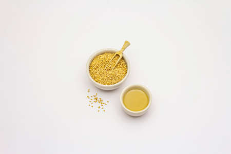 Tahini with sesame seeds isolated on white background. Indispensable ingredient for cooking hummus. Middle Eastern and Mediterranean cuisineの写真素材