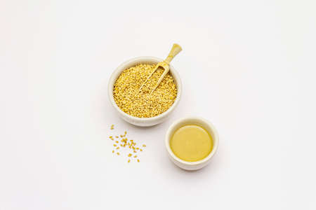 Tahini with sesame seeds isolated on white background. Indispensable ingredient for cooking hummus. Middle Eastern and Mediterranean cuisineの写真素材