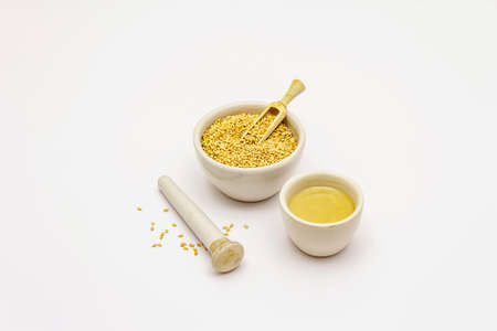 Tahini with sesame seeds isolated on white background. Indispensable ingredient for cooking hummus. Middle Eastern and Mediterranean cuisineの写真素材