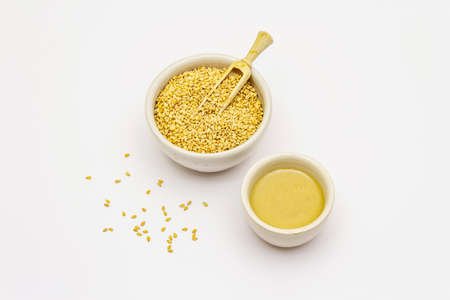 Tahini with sesame seeds isolated on white background. Indispensable ingredient for cooking hummus. Middle Eastern and Mediterranean cuisineの写真素材