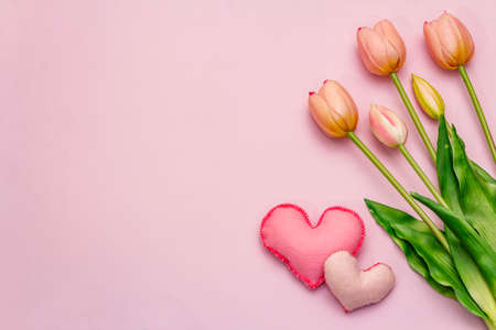 Greetings card, wallpaper, backdrop. Happy Mothers Day, Easter, St.Valentines or Wedding. Gentle pink tulips, handmade felt hearts on rosy backgroundの写真素材