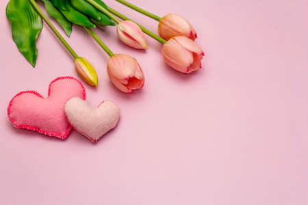 Greetings card, wallpaper, backdrop. Happy Mothers Day, Easter, St.Valentines or Wedding. Gentle pink tulips, handmade felt hearts on rosy backgroundの写真素材