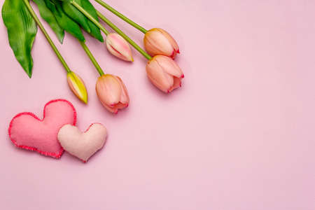 Greetings card, wallpaper, backdrop. Happy Mothers Day, Easter, St.Valentines or Wedding. Gentle pink tulips, handmade felt hearts on rosy backgroundの写真素材