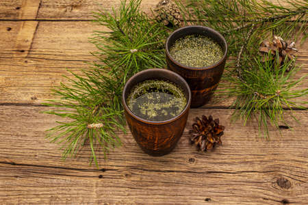 Pine needle tea, sollip-cha, traditional Korean beverage. Alternative medicine, healthy life style. Vintage wooden boards backgroundの写真素材