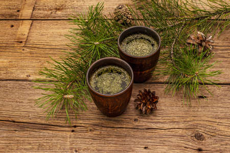 Pine needle tea, sollip-cha, traditional Korean beverage. Alternative medicine, healthy life style. Vintage wooden boards backgroundの写真素材