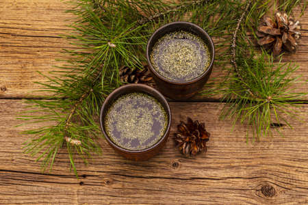 Pine needle tea, sollip-cha, traditional Korean beverage. Alternative medicine, healthy life style. Vintage wooden boards backgroundの写真素材