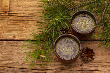Pine needle tea, sollip-cha, traditional Korean beverage. Alternative medicine, healthy life style. Vintage wooden boards backgroundの写真素材