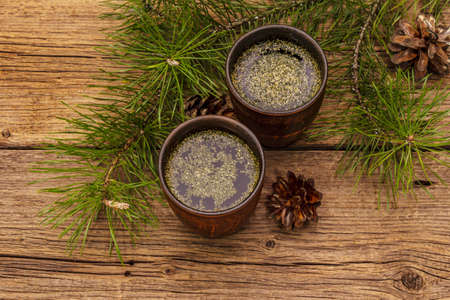 Pine needle tea, sollip-cha, traditional Korean beverage. Alternative medicine, healthy life style. Vintage wooden boards backgroundの写真素材