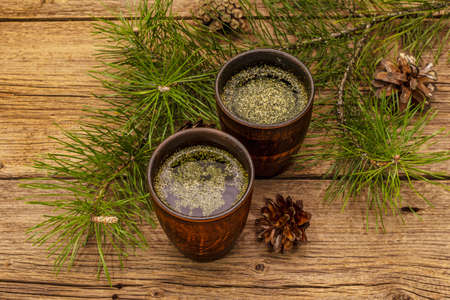 Pine needle tea, sollip-cha, traditional Korean beverage. Alternative medicine, healthy life style. Vintage wooden boards backgroundの写真素材