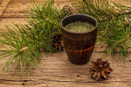 Pine needle tea, sollip-cha, traditional Korean beverage. Alternative medicine, healthy life style. Vintage wooden boards backgroundの写真素材