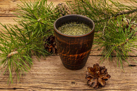 Pine needle tea, sollip-cha, traditional Korean beverage. Alternative medicine, healthy life style. Vintage wooden boards backgroundの写真素材