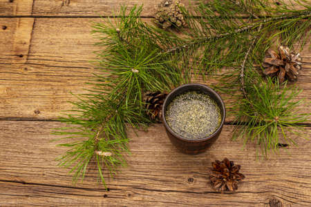 Pine needle tea, sollip-cha, traditional Korean beverage. Alternative medicine, healthy life style. Vintage wooden boards backgroundの写真素材