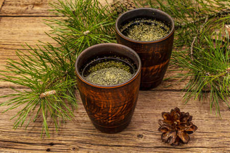 Pine needle tea, sollip-cha, traditional Korean beverage. Alternative medicine, healthy life style. Vintage wooden boards backgroundの写真素材