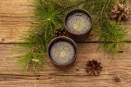 Pine needle tea, sollip-cha, traditional Korean beverage. Alternative medicine, healthy life style. Vintage wooden boards backgroundの写真素材